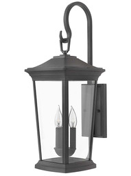 Bromley Medium Outdoor Wall-Mount Lantern with Scrolled Arm in Museum Black.